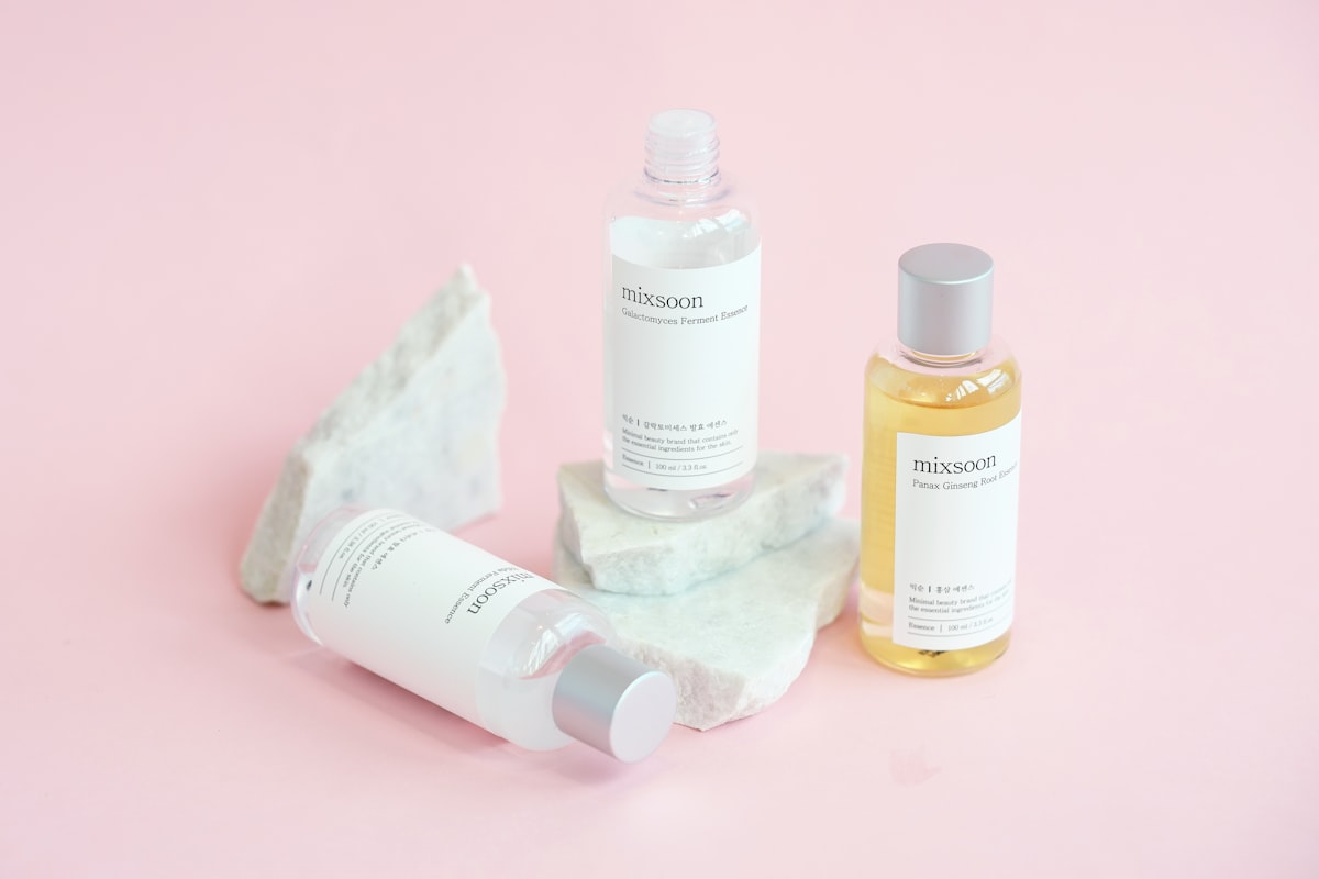 Skincare bottles arranged on pale marble